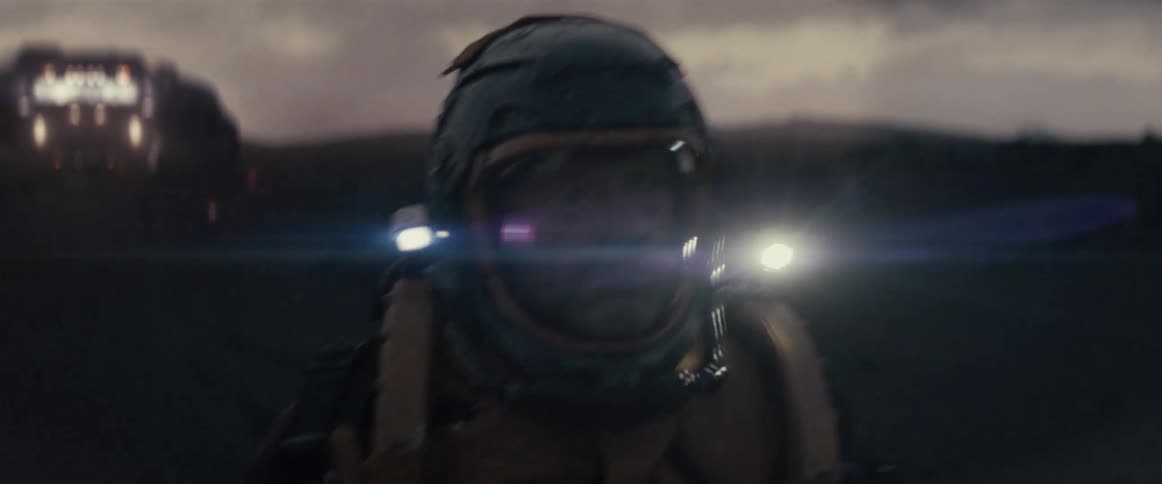 An astronaut walks away from a spaceship to explore a planet