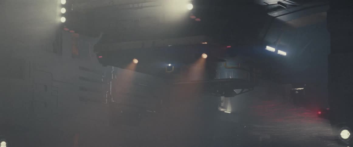 A person stands on a platform as it lowers from a spacecraft