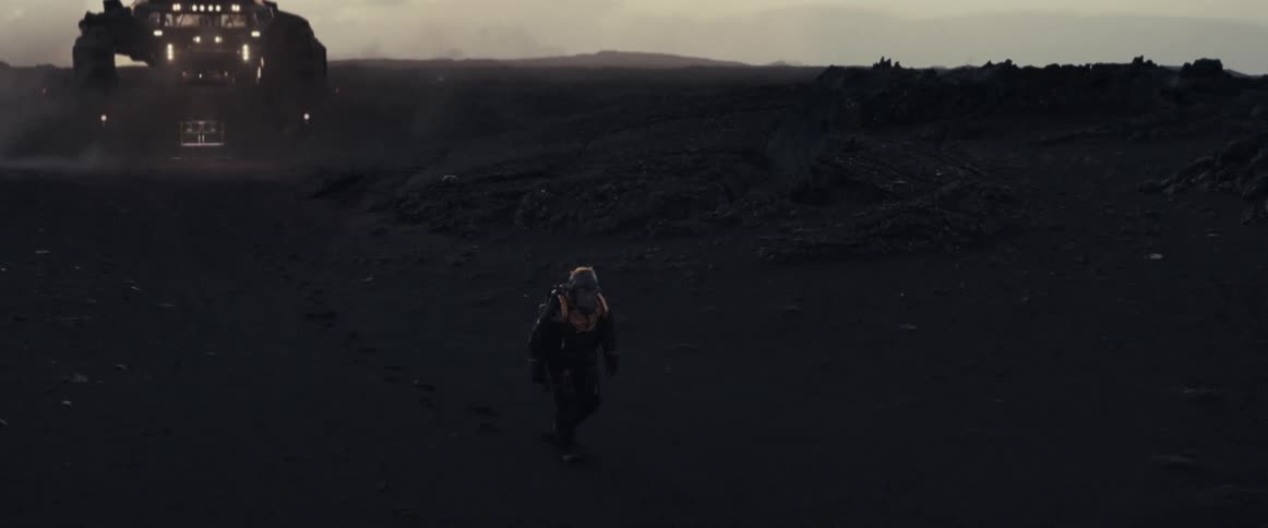 Floating spacecraft follows a person wearing a futuristic space suit as they walk across land at night