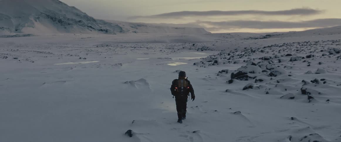 Man is hiking by himself through an arctic landscape