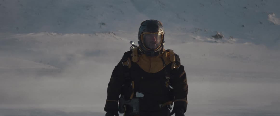 A futuristic astronaut walks across a snow covered surface
