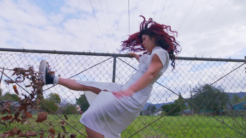 A woman slips and falls by the fence