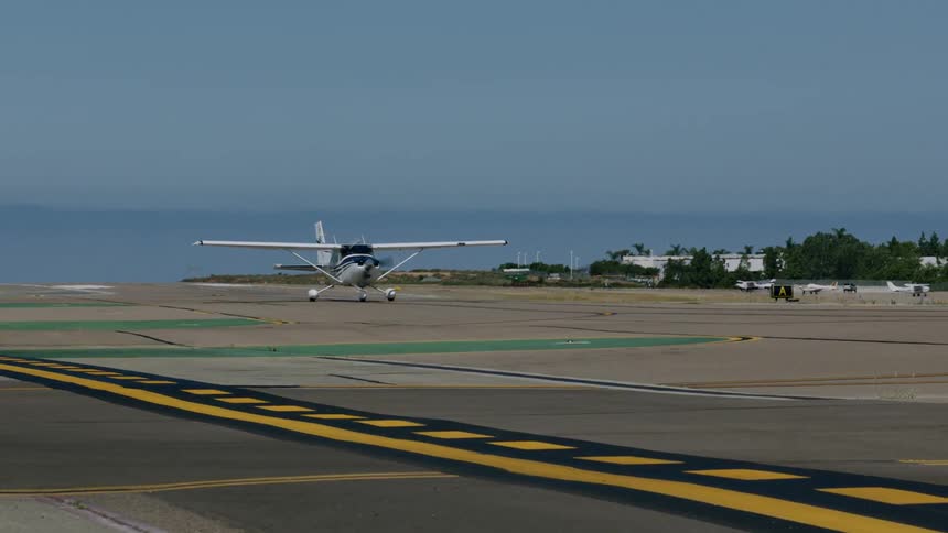 A single engine plane taxiing on an airport runway