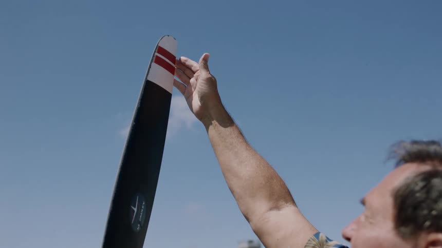 A man inspects the blade of an airplane propeller
