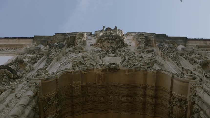 A large archway is accented with numerous detailed sculptures