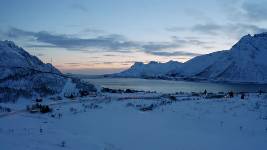 Aerial panorama of mountains by a lake on a dusk day