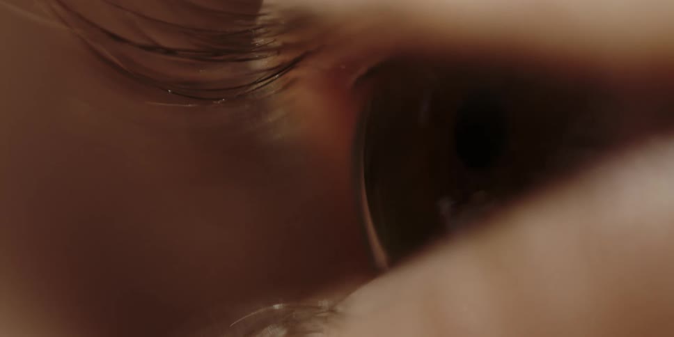 Extreme closeup of a womans eye opening