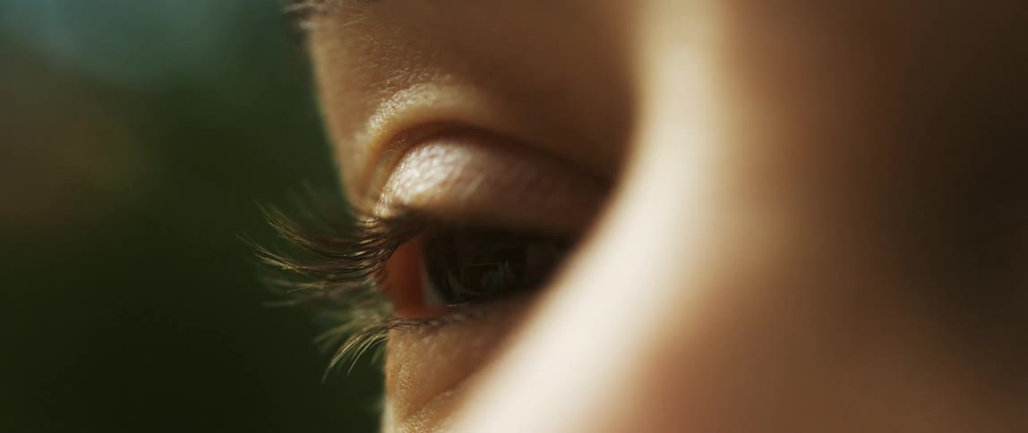 A human is slowly closing their eye