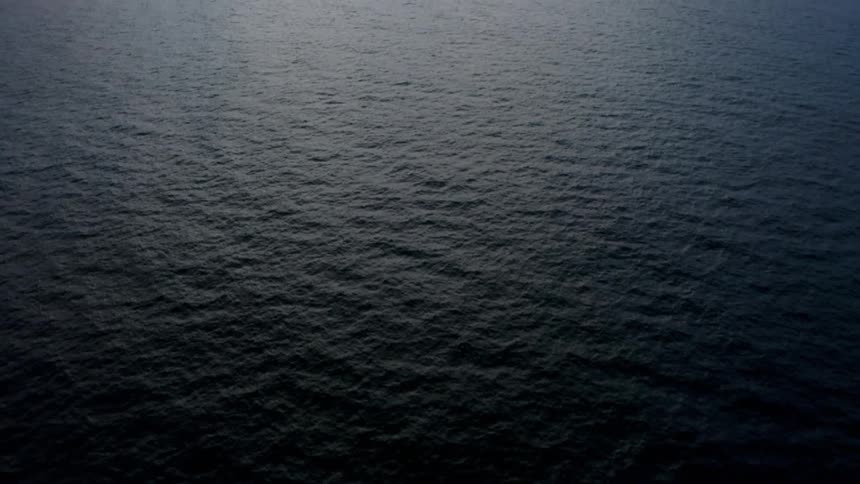 A mountain range forms a coast line for a vast ocean
