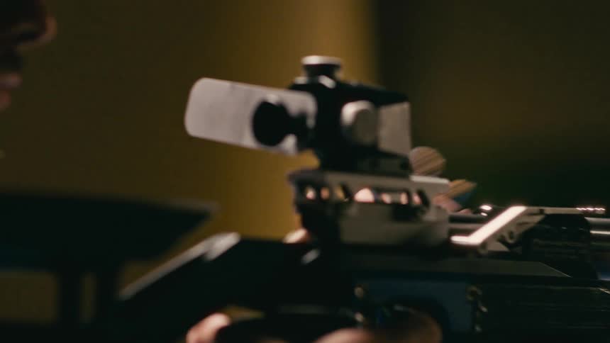Man placing ammunition and preparing to shoot a gun