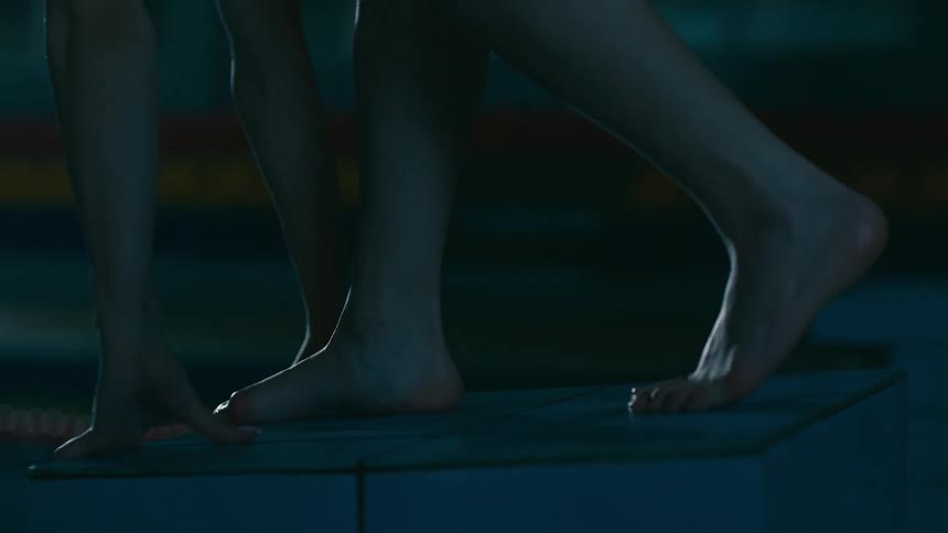 A person is getting ready to dive into a pool