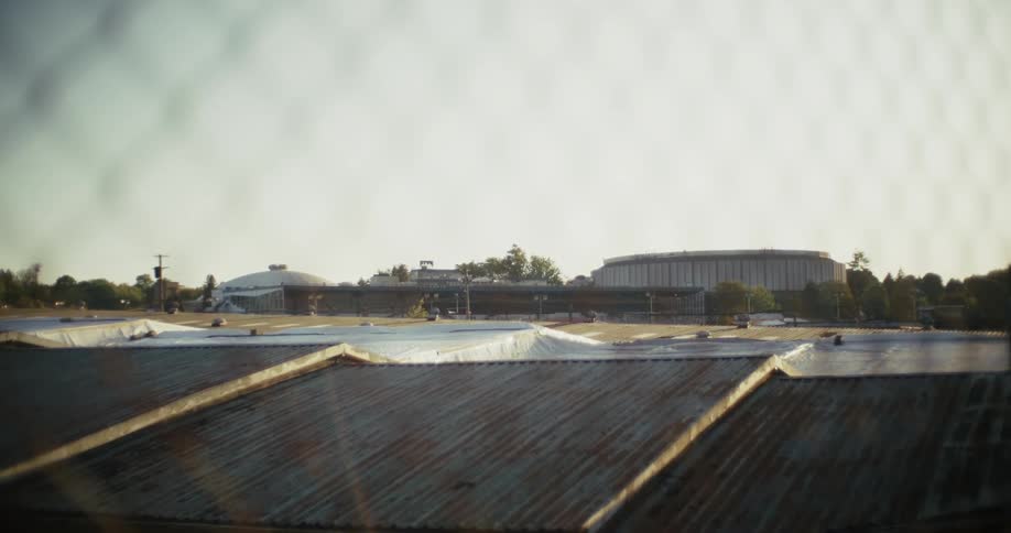 Tarp covering the ground in front of a building in the distance