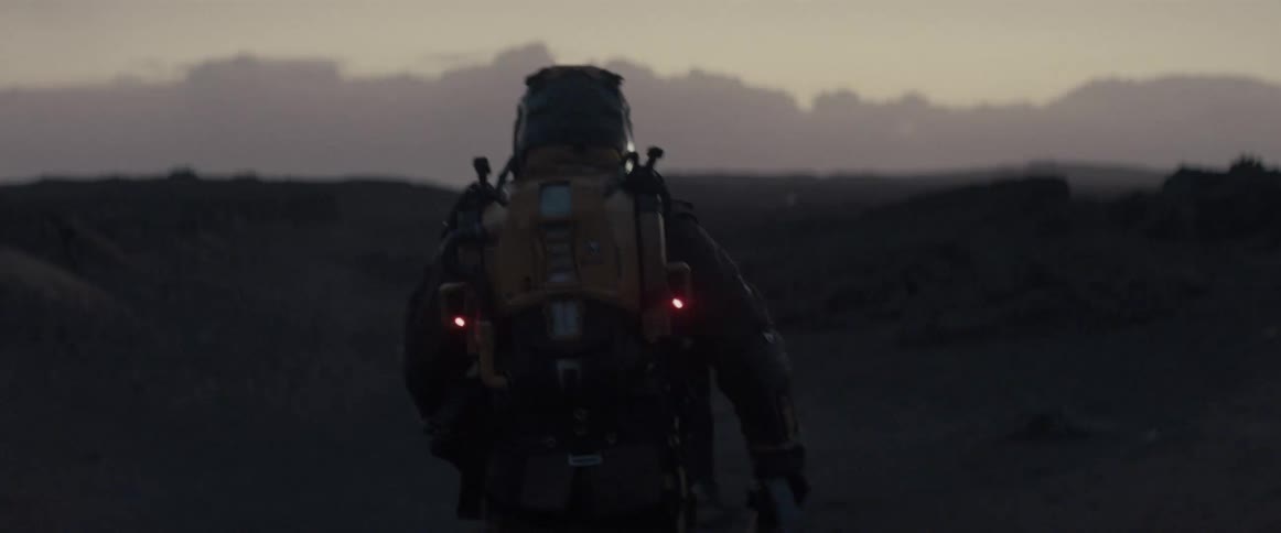 An astronaut walks towards clouds lit up with lightening