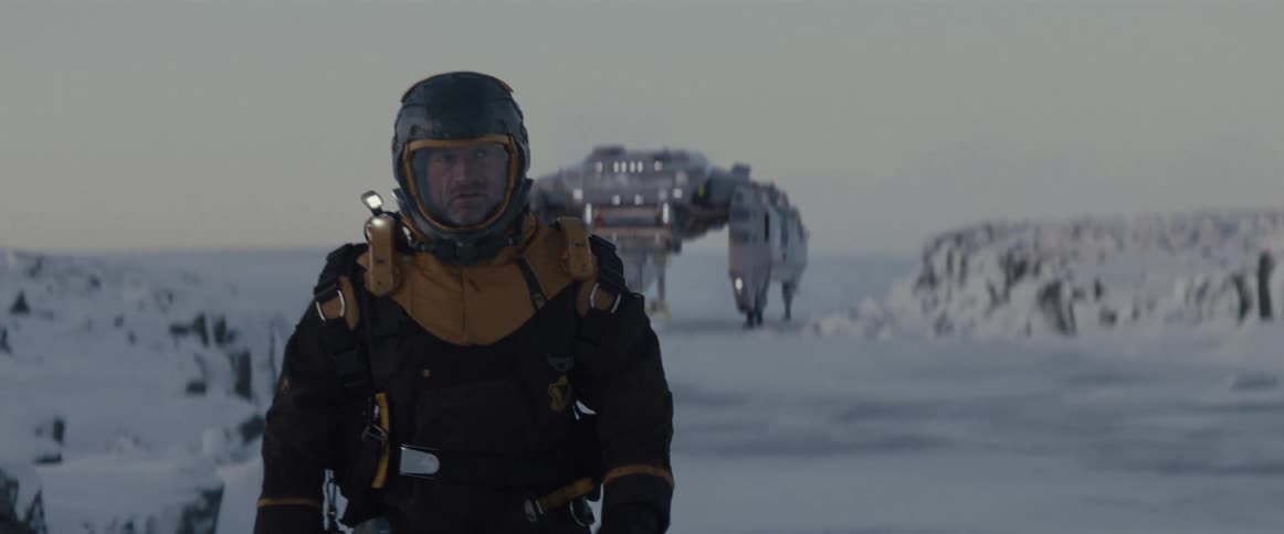 An astronaut walks away from his spaceship on a snowy planet