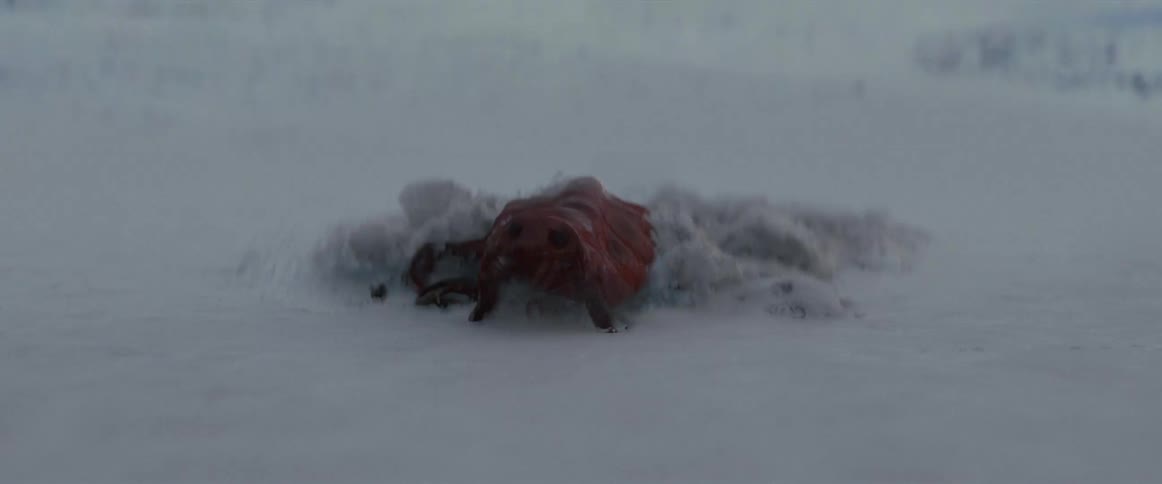 An alien creature with tentacles crawls out of ice