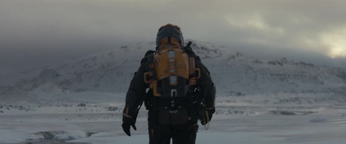 A futuristic astronaut takes a stroll over a snow covered plain