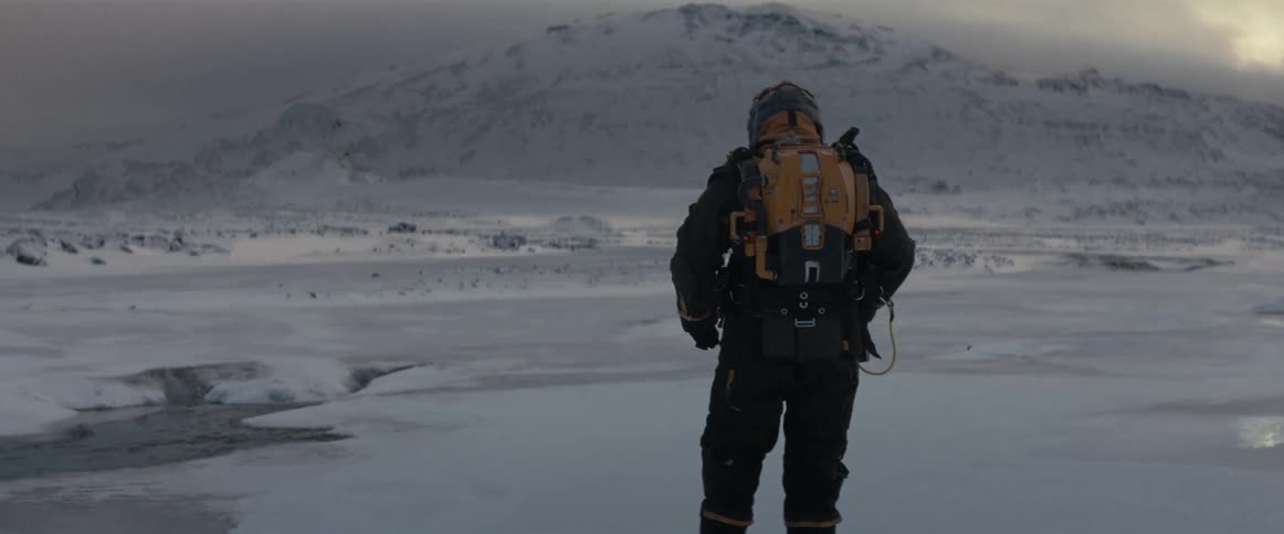 Explorer crosses the ice to head toward the mountain ahead of them