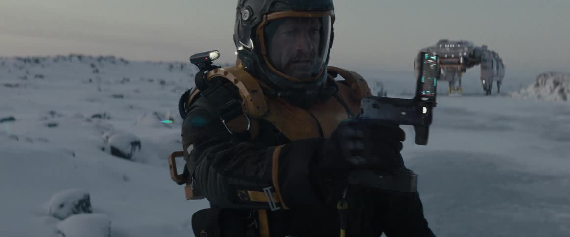 A space man wearing a futuristic space suit scans a snowy landscape