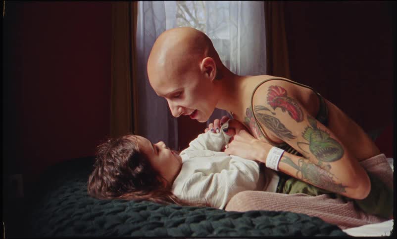 Mother sitting on the bed with her daughter face to face