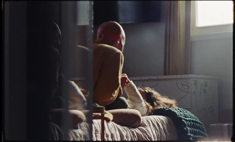 Mother playing in bed with her daughter