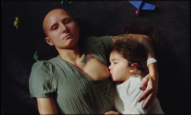 Woman lying down breastfeeding her little daughter