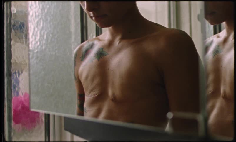 Woman in the bathroom rubbing her breasts that have been removed