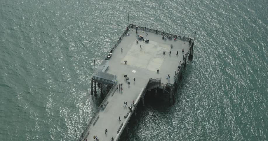 Dock in the middle of the sea with tourists