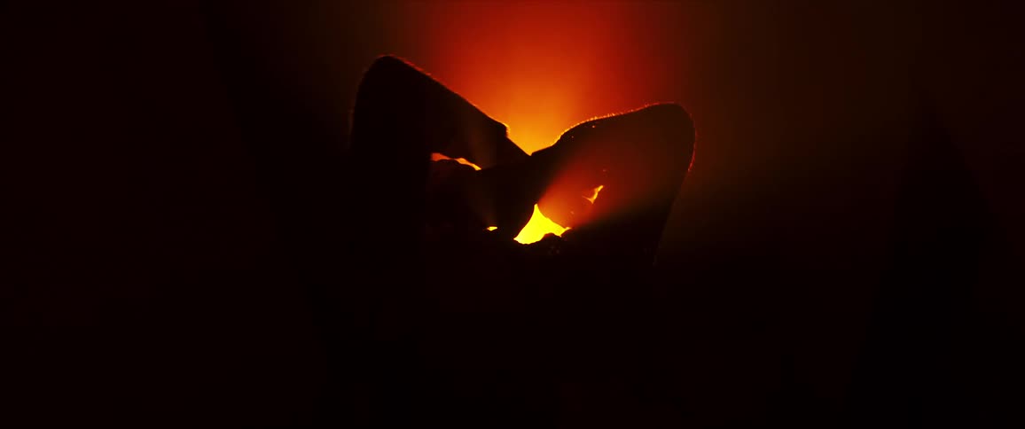 A black dancer lit up from behind by a stage light