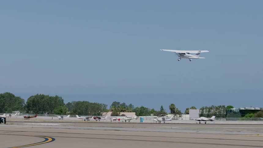 Light aircraft taking off from the runway at an airport