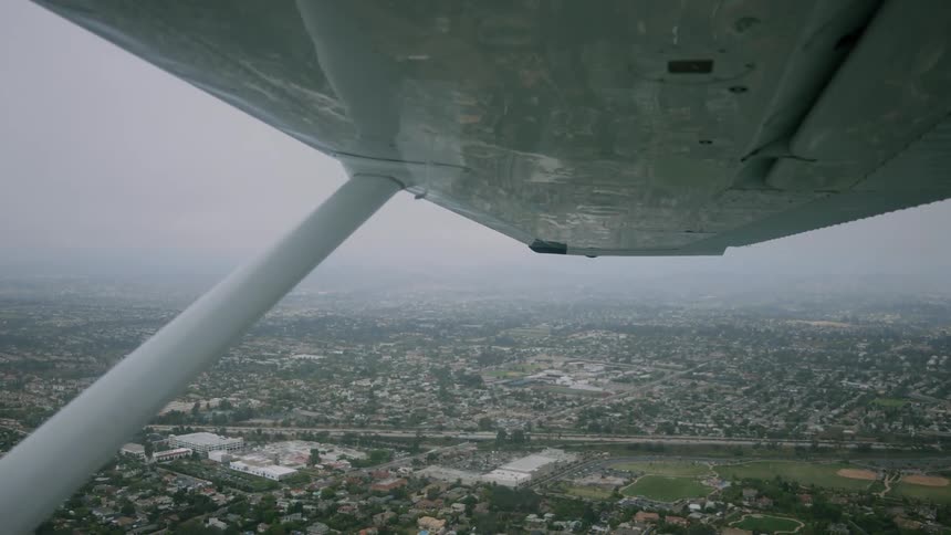 A plane flies over the neighborhood