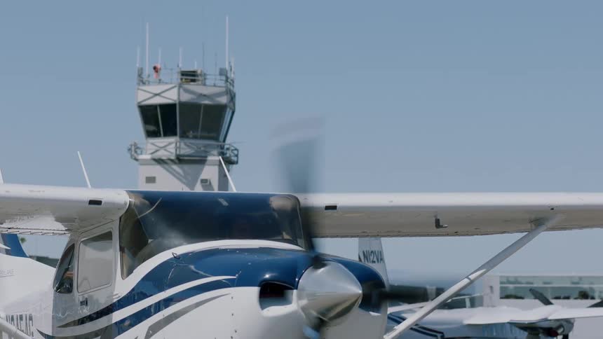 A small airplane begins taxiing to a runway at an airport