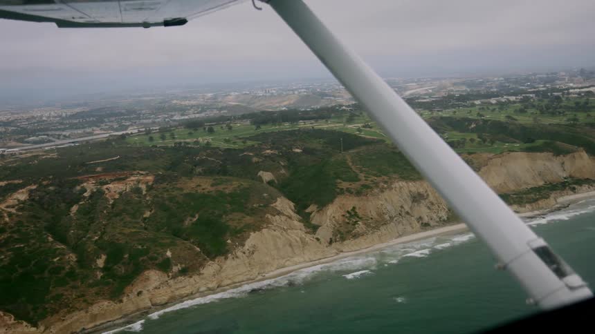 Small plane flying over the coast