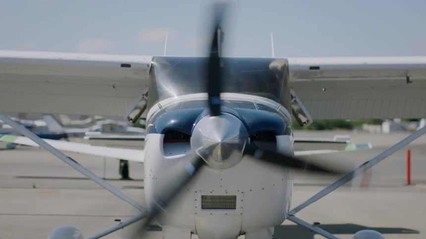 A parked plane is getting ready to take off at midday