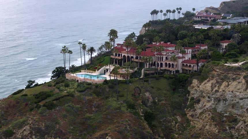 Giant homes sit on a coastal area