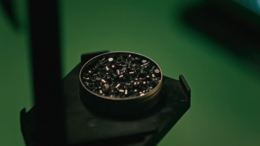 A person grabs a pellet from the container