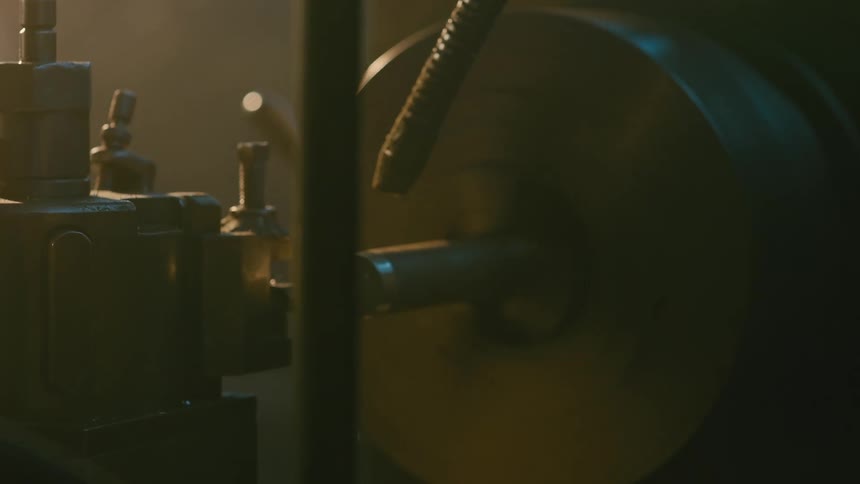 A closeup view of a lathe focusing on the chuck and workpiece