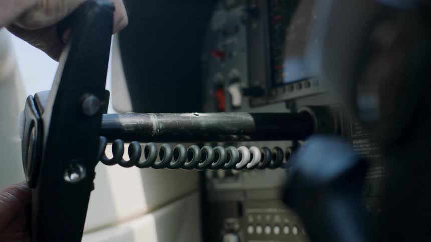 A human hand generating an aircraft steering wheel and a panel with several buttons