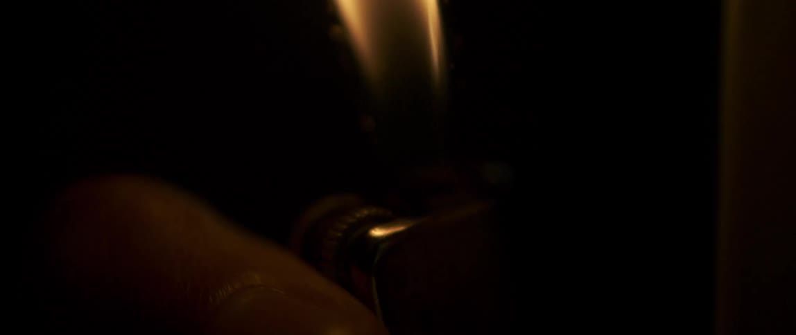Finger pressing the trigger of a lighter