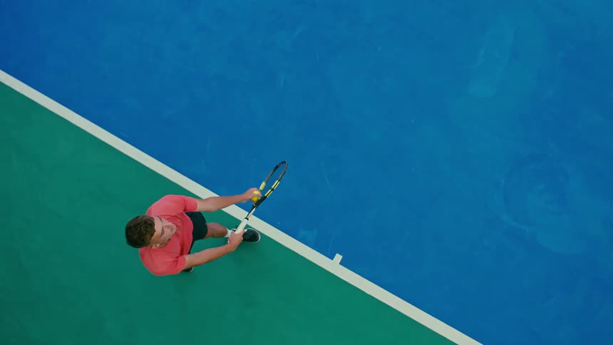 Overhead view serving a tennis ball across the tennis court