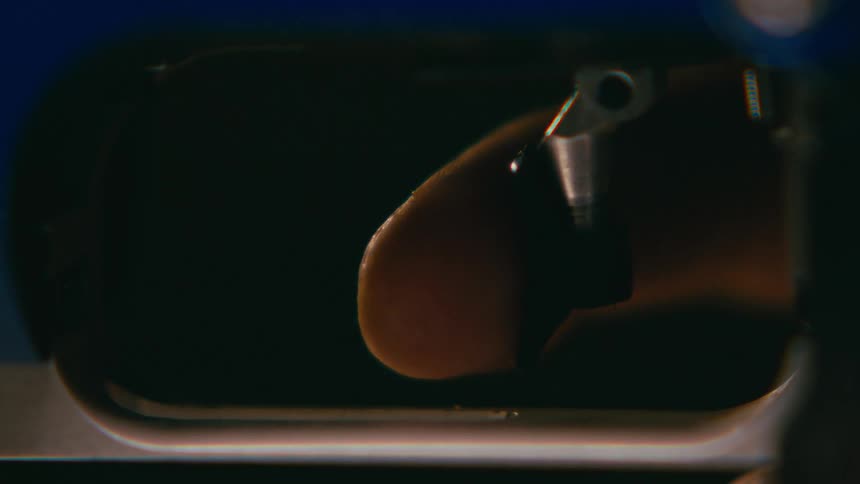 Closeup of a finger pressing a gun trigger