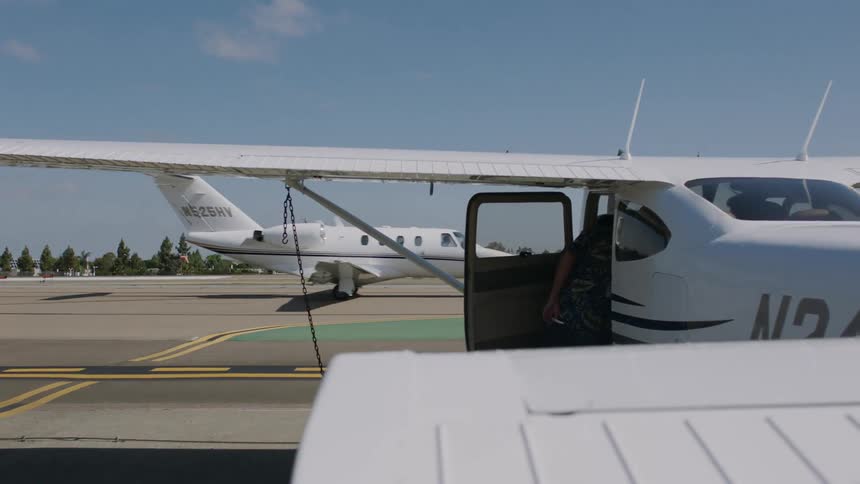 Small airplane rolls across the tarmac either returning from a flight or preparing for takeoff