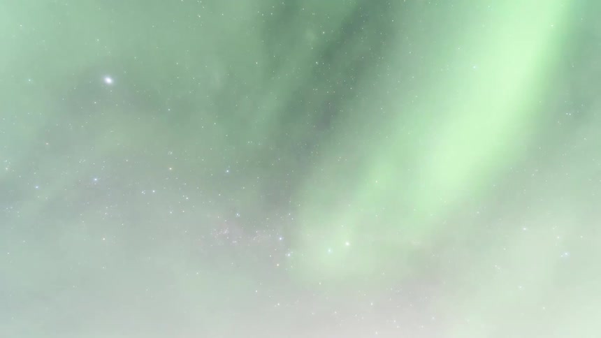 Spectacular view of space with stars and nebulae dotting the sky and the northern lights