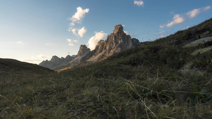 Panorama of rocky mountain ranges against a partly cloudy sky