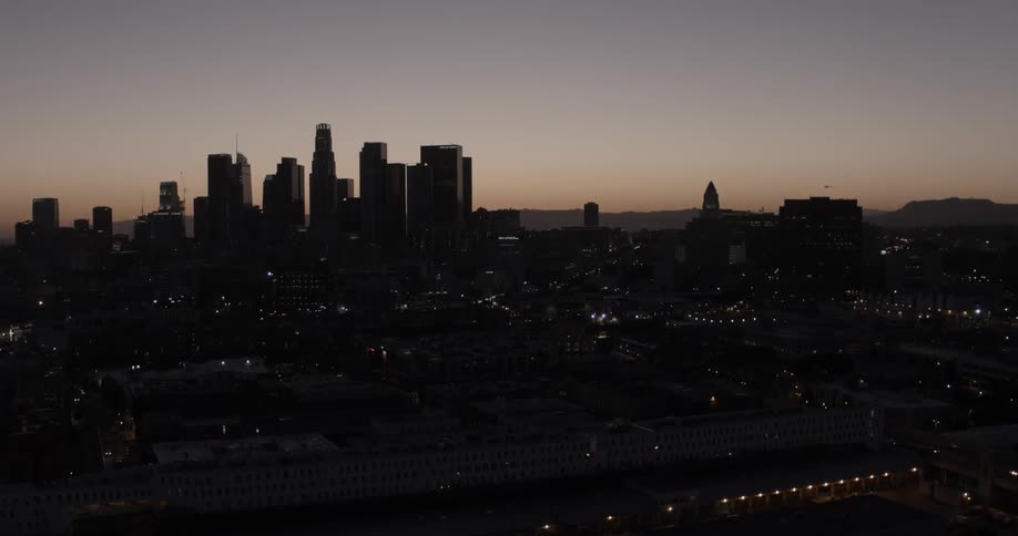 Aerial view of a large city skyline at sunset