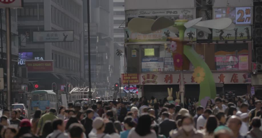 A busy asian city is crowded with pedestrians