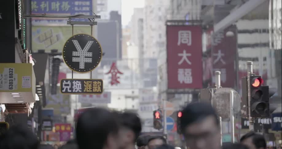 Crowds of people walking on street in Hong Kong