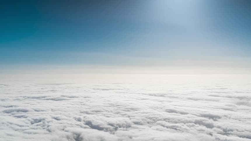 Aerial panorama of a sea of clouds against a blue sky