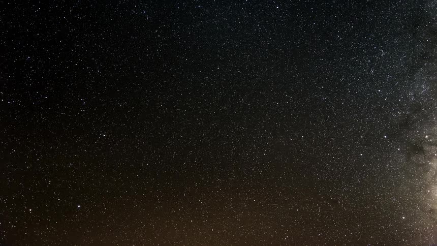 Starry sky over dark mountains