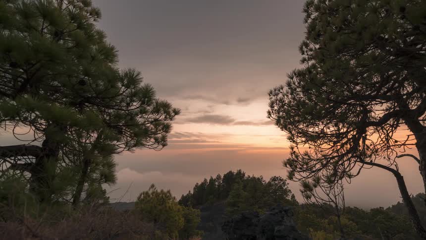 Time lapse of sunset over a landscape covered in clouds
