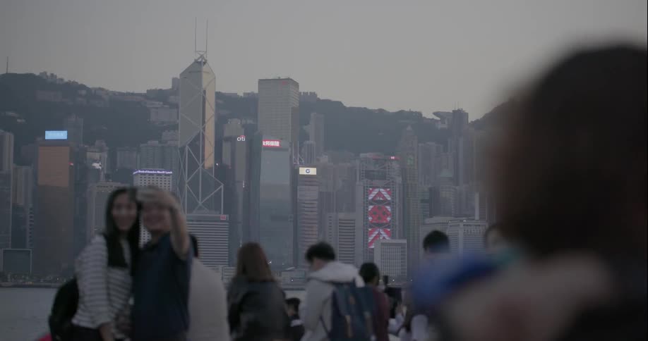 People are sight seeing together with a large city behind